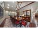 Formal dining room with vaulted ceilings, long wood table, built-in display cabinets, and tile flooring at 1835 Alicia Way, Clearwater, FL 33764