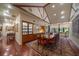 Elegant dining room with long wood table, display cabinets, and vaulted ceilings with wood beams at 1835 Alicia Way, Clearwater, FL 33764
