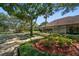 Charming home with meticulously landscaped front yard, showcasing lush greenery at 1835 Alicia Way, Clearwater, FL 33764