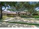 Beautifully landscaped front yard with mature trees and manicured gardens accenting a single-story home at 1835 Alicia Way, Clearwater, FL 33764
