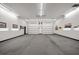 Spacious garage featuring multiple garage doors, providing ample room for vehicle storage and projects at 1835 Alicia Way, Clearwater, FL 33764