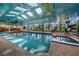 Bright indoor pool features skylights, murals, ceiling fans, and an attached hot tub at 1835 Alicia Way, Clearwater, FL 33764