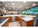 Open kitchen with stainless steel appliances and views of the indoor pool and living space at 1835 Alicia Way, Clearwater, FL 33764