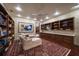 Inviting library featuring custom built-in bookshelves, soft lighting and unique decor at 1835 Alicia Way, Clearwater, FL 33764