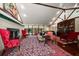 Spacious living room features a fireplace, large windows, and vaulted ceilings with exposed beams at 1835 Alicia Way, Clearwater, FL 33764