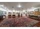 Spacious living room with hardwood floors, a decorative Persian rug, and a curated collection of artwork at 1835 Alicia Way, Clearwater, FL 33764
