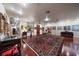 Expansive living room with hardwood floors, a Persian rug, and an array of exquisite artwork at 1835 Alicia Way, Clearwater, FL 33764