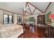 Spacious main bedroom featuring hardwood floors, vaulted ceilings and unique decor at 1835 Alicia Way, Clearwater, FL 33764