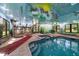 Indoor pool with a full kitchen and bar area, as well as a jacuzzi and grill at 1835 Alicia Way, Clearwater, FL 33764