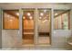 Home sauna with wood paneling and a tiled standing shower at 1835 Alicia Way, Clearwater, FL 33764