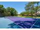 A tennis court nestled amongst mature trees and beautiful landscaping at 1835 Alicia Way, Clearwater, FL 33764
