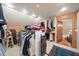 Lofted walk-in closet with built-ins, clothing racks and carpeted stairs at 1835 Alicia Way, Clearwater, FL 33764