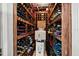 Well-stocked wine cellar with wooden racks filled with various wines at 1835 Alicia Way, Clearwater, FL 33764