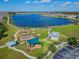Aerial showcases community park amenities, playgrounds, picnic shelters, and scenic walking trails by the lake at 19656 Long Lake Ranch Blvd, Lutz, FL 33558
