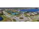Aerial view of the community featuring tennis courts, lake and resort-style pool at 19656 Long Lake Ranch Blvd, Lutz, FL 33558