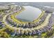 Expansive aerial shot of a community encircling a large lake, showcasing beautiful homes at 19656 Long Lake Ranch Blvd, Lutz, FL 33558