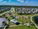 Aerial perspective of a neighborhood park featuring playgrounds, picnic areas, and walking paths at 19656 Long Lake Ranch Blvd, Lutz, FL 33558
