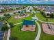Aerial view of neighborhood park, featuring a playground, covered seating area, and walking paths at 19656 Long Lake Ranch Blvd, Lutz, FL 33558