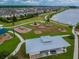 Aerial view showcases community park amenities, playgrounds, picnic shelters, and scenic walking trails by the lake at 19656 Long Lake Ranch Blvd, Lutz, FL 33558