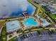 An aerial view of a resort-style pool, pier and community buildings next to parking at 19656 Long Lake Ranch Blvd, Lutz, FL 33558