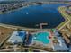 Aerial view of a neighborhood with a pool, lake, pier, and community buildings at 19656 Long Lake Ranch Blvd, Lutz, FL 33558