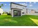View of the back exterior of the home with a covered patio and well maintained lawn at 19656 Long Lake Ranch Blvd, Lutz, FL 33558