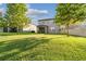 Spacious backyard with green lawn and the rear exterior of the house featuring a covered patio at 19656 Long Lake Ranch Blvd, Lutz, FL 33558