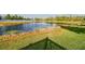 This backyard boasts a pond view with lush greenery and aquatic plants, creating a peaceful oasis at 19656 Long Lake Ranch Blvd, Lutz, FL 33558