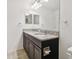 Bathroom featuring double vanity with granite countertop and framed mirrors at 19656 Long Lake Ranch Blvd, Lutz, FL 33558