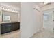 Bright bathroom with granite counters, dual vanity, neutral walls and carpet in hallway at 19656 Long Lake Ranch Blvd, Lutz, FL 33558
