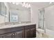 Bright bathroom with granite counters, dual vanity, neutral walls and bathtub shower at 19656 Long Lake Ranch Blvd, Lutz, FL 33558
