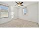 Bright bedroom with ceiling fan, carpet floors and two windows at 19656 Long Lake Ranch Blvd, Lutz, FL 33558