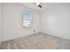 Neutral bedroom with gray carpet and a window overlooking the yard at 19656 Long Lake Ranch Blvd, Lutz, FL 33558