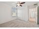 Neutral bedroom with a ceiling fan, a window, and a closet at 19656 Long Lake Ranch Blvd, Lutz, FL 33558