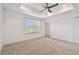 Spacious bedroom with a ceiling fan and large window for natural light at 19656 Long Lake Ranch Blvd, Lutz, FL 33558
