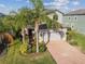 Beautiful two-story home features a well-manicured lawn and a brick driveway leading to the attached two-car garage at 19656 Long Lake Ranch Blvd, Lutz, FL 33558