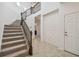 Bright foyer with tile floors, decorative wall and carpeted stairs with iron railing at 19656 Long Lake Ranch Blvd, Lutz, FL 33558