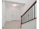 Bright foyer featuring tile floors, white walls and a staircase with wood railing at 19656 Long Lake Ranch Blvd, Lutz, FL 33558