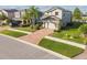 This property boasts an attractive two-story home with a brick driveway, well-kept lawn, and mature palm trees at 19656 Long Lake Ranch Blvd, Lutz, FL 33558
