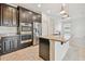 Stylish kitchen island featuring granite countertops, stainless steel appliances, and dark wood cabinets at 19656 Long Lake Ranch Blvd, Lutz, FL 33558