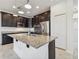 Modern kitchen island with granite countertops, stainless steel appliances, and elegant pendant lighting at 19656 Long Lake Ranch Blvd, Lutz, FL 33558