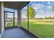 Screened lanai featuring blue flooring, a large yard and water view at 19656 Long Lake Ranch Blvd, Lutz, FL 33558