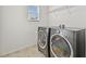 Bright laundry room featuring side-by-side washer and dryer set at 19656 Long Lake Ranch Blvd, Lutz, FL 33558