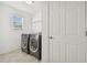 Laundry room with side-by-side washer and dryer and tile flooring at 19656 Long Lake Ranch Blvd, Lutz, FL 33558