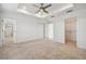 This spacious main bedroom features a tray ceiling with fan, carpet floors and a walk-in closet at 19656 Long Lake Ranch Blvd, Lutz, FL 33558