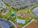 Aerial shot of a community playground with slides, swings, and shaded seating areas at 19656 Long Lake Ranch Blvd, Lutz, FL 33558