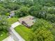 Aerial view of home with screened in pool and lush landscaping at 2409 Heather Manor Ln, Lutz, FL 33549