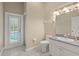 Well-lit bathroom with granite countertop and walk-in shower access to the pool area at 2409 Heather Manor Ln, Lutz, FL 33549