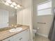 Bathroom featuring granite vanity, tile flooring, and walk-in shower at 2409 Heather Manor Ln, Lutz, FL 33549