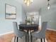 Cozy dining room with seating for four and elegant chandelier lighting at 2409 Heather Manor Ln, Lutz, FL 33549